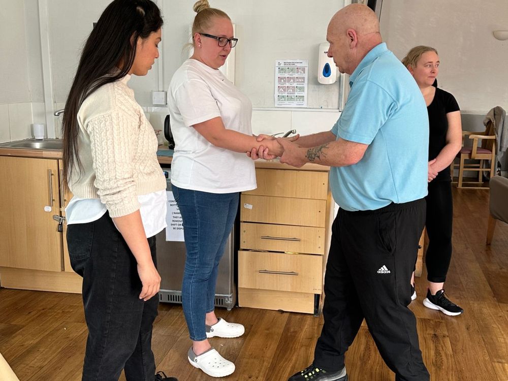 Staff practising safe holds during behaviour management training