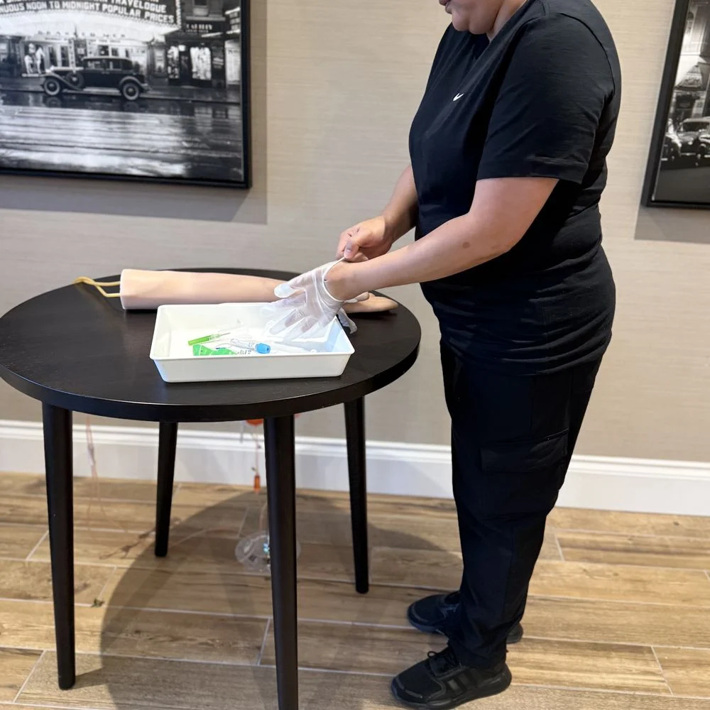 Delegate preparing equipment for arm practice with gloves and tray