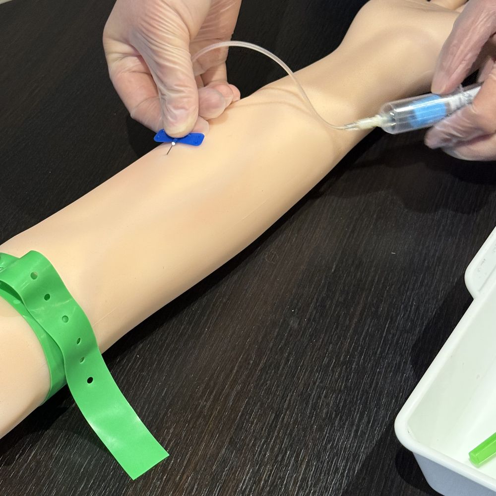 Close-up of venepuncture and IV cannulation practice
