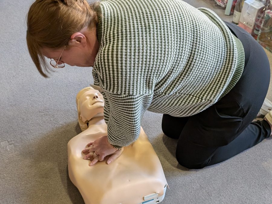 CPR chest compressions practised on a training manikin
