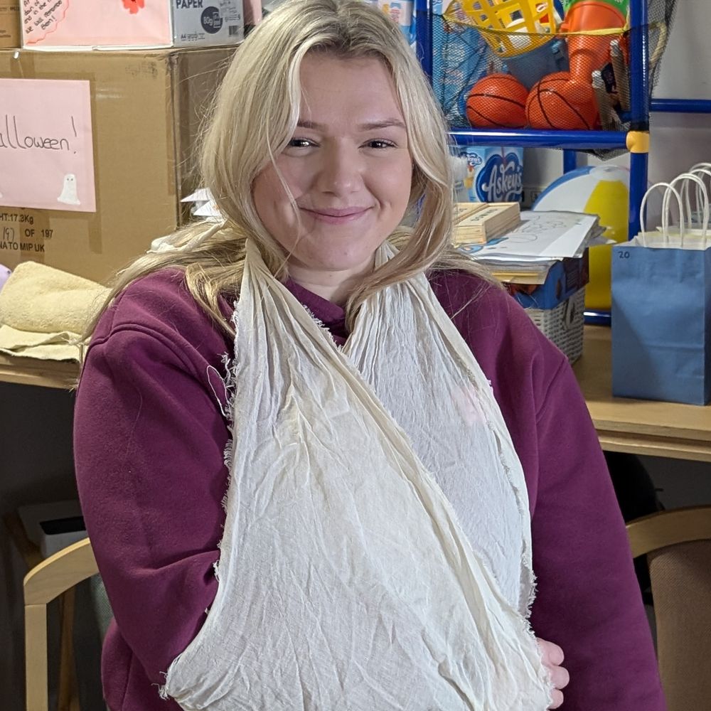 Applying an arm sling during first aid training
