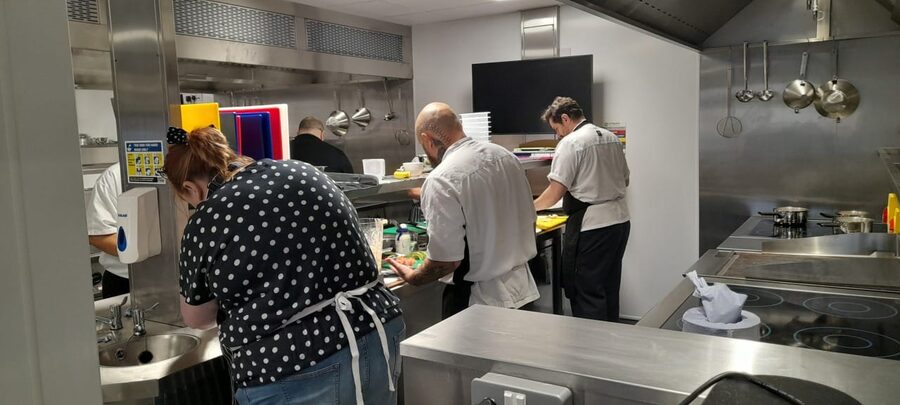 Delegates working at kitchen stations during food training