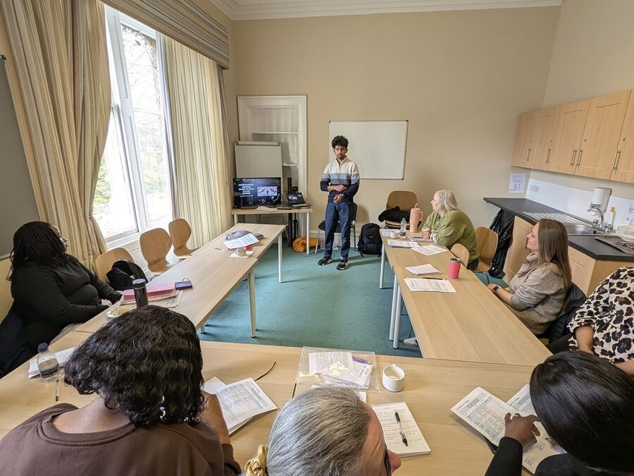 A trainer leading a session for a room of delegates