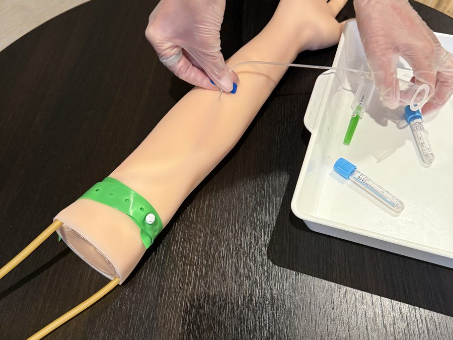 Venepuncture equipment and training arm set up on the table