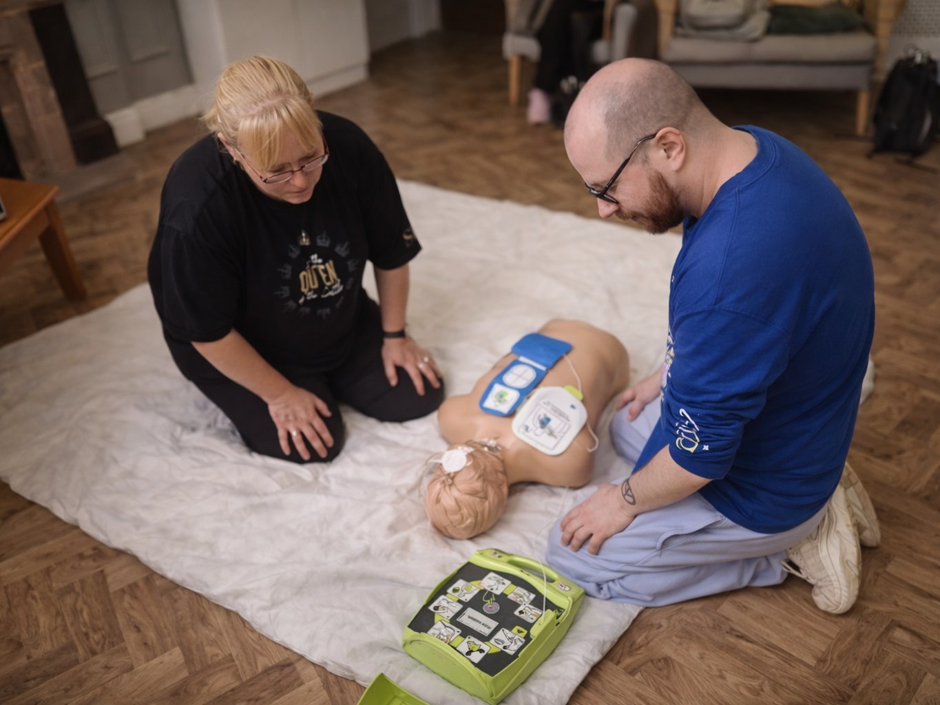 Using a defibrillator on a training manikin