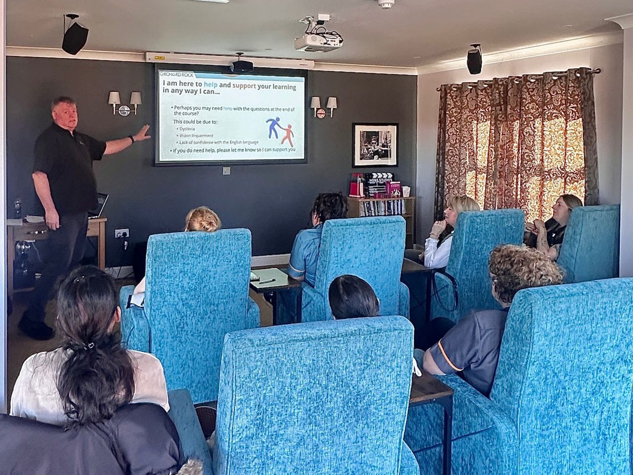 An Orchard Rock trainer presenting to care staff during a classroom training session